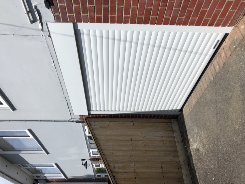 Electric roller garage door in white