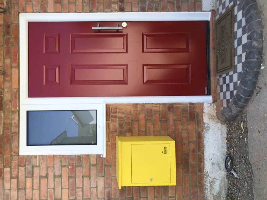 Red front door installed by 1st Garage Doors